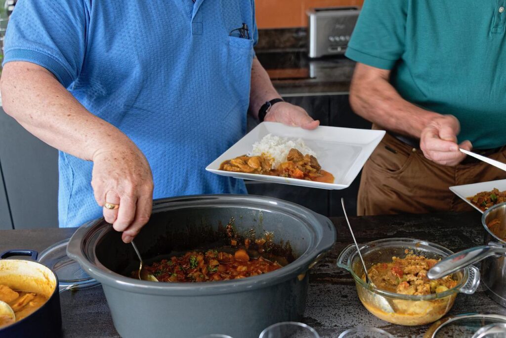 A man serving food onto his plate
