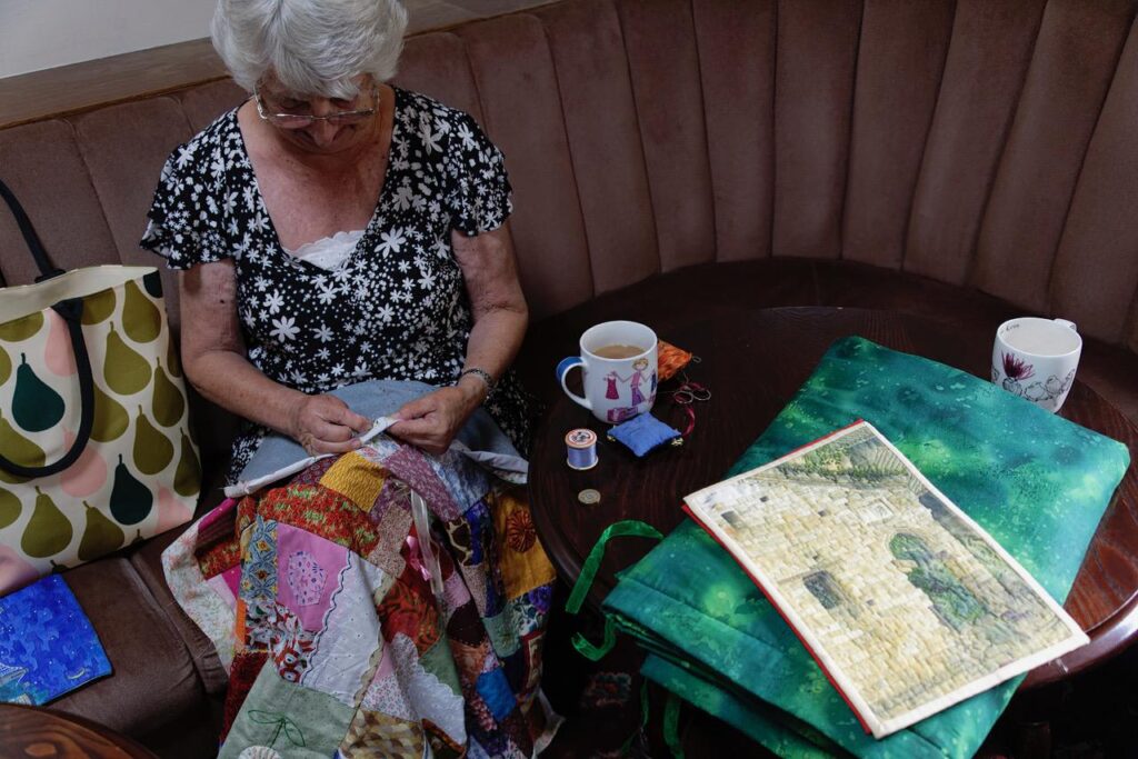 Woman sewing a patchwork quilt